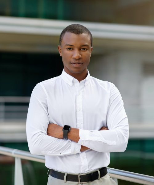 Portrait Of Handsome Black Businessman In Shirt Standing With Folded Arms
